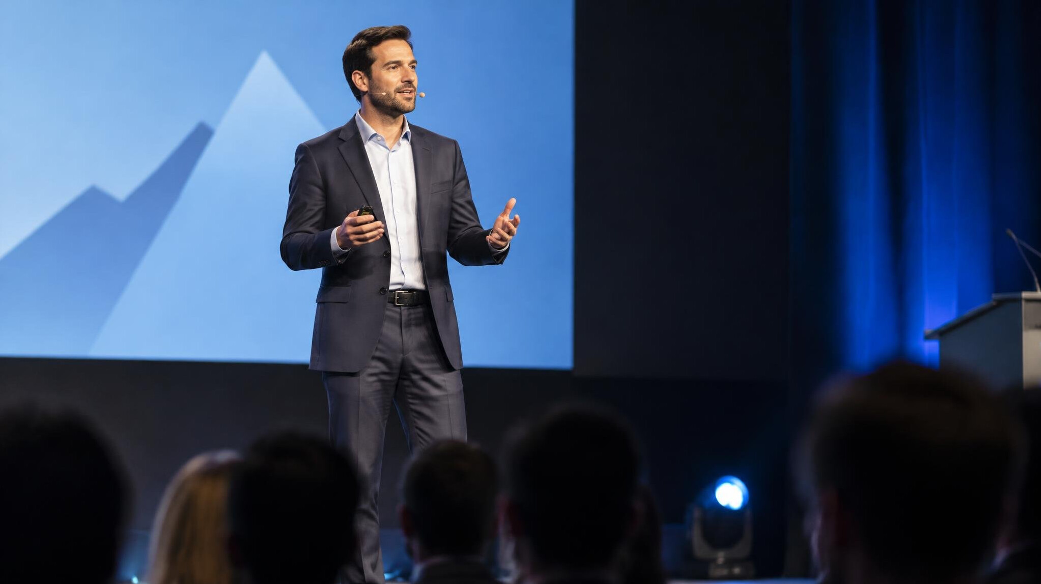 executive on stage presenting